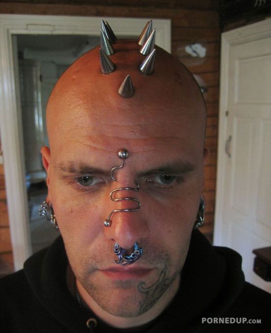 man with crazy head spike piercings