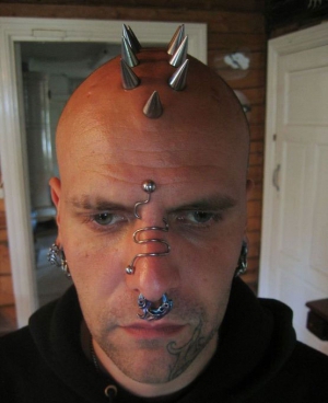 man with crazy head spike piercings