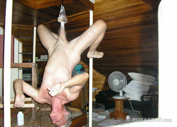 hanging upside down by his balls
