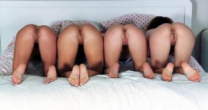 Four girls bending over on a bed showing off