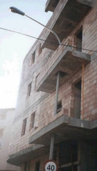 Light pole goes through building balcony