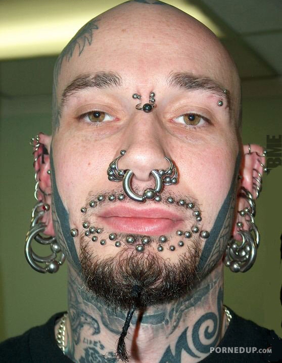 tons of piercings on this guys face